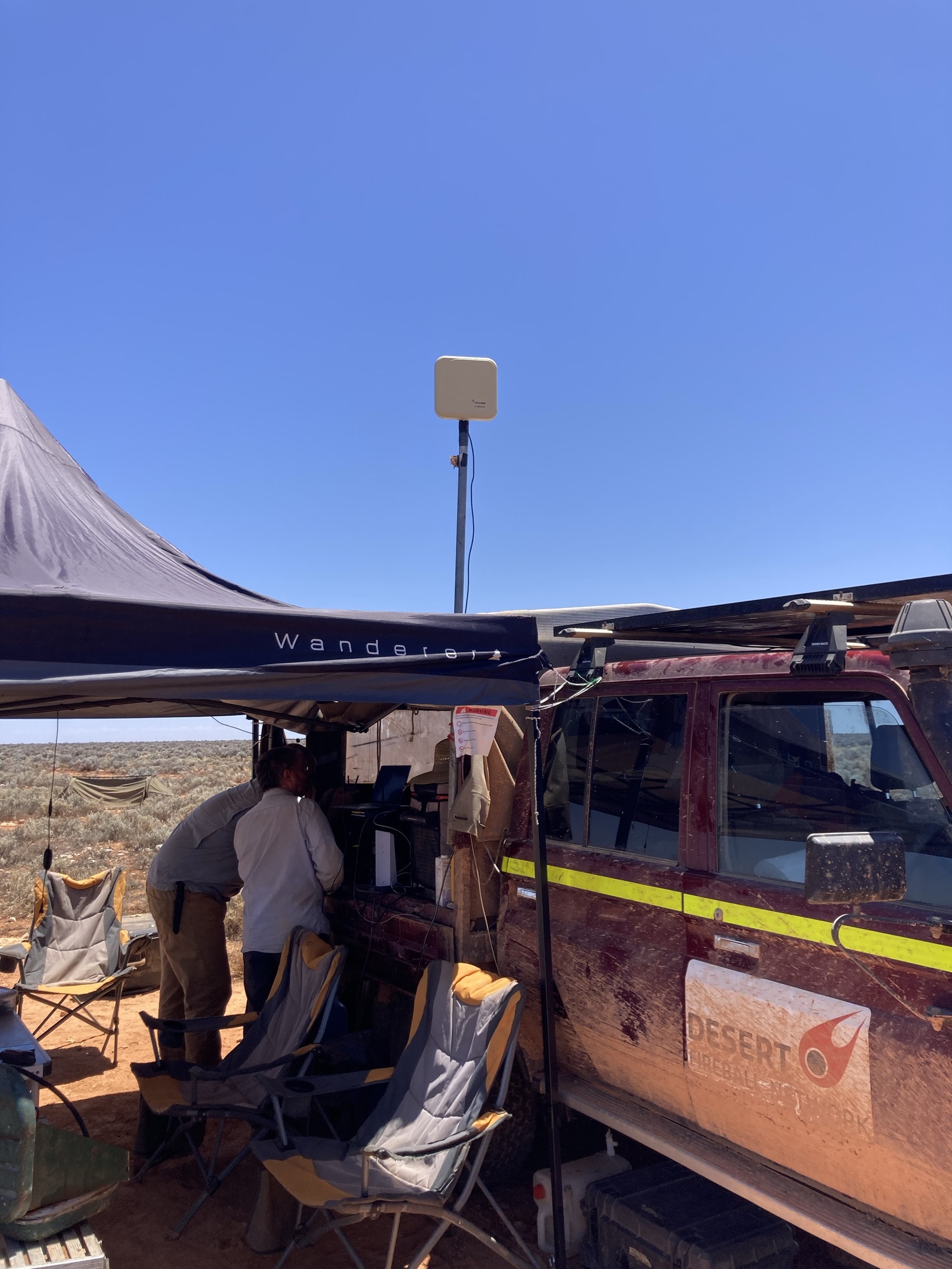 The wifi extender raised high and pointing towards our search area.